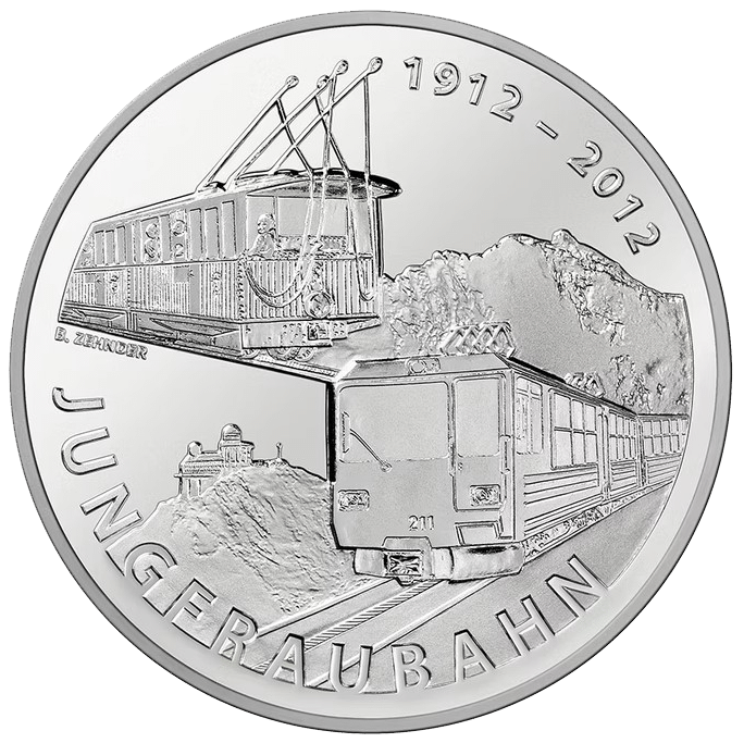 Commemorative coin for Jungfraubahn, showing a train on tracks with mountains and the years 1912–2012.
