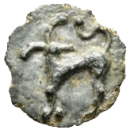 Worn ancient silver coin featuring a cross and a curved decorative mark on its irregular surface.